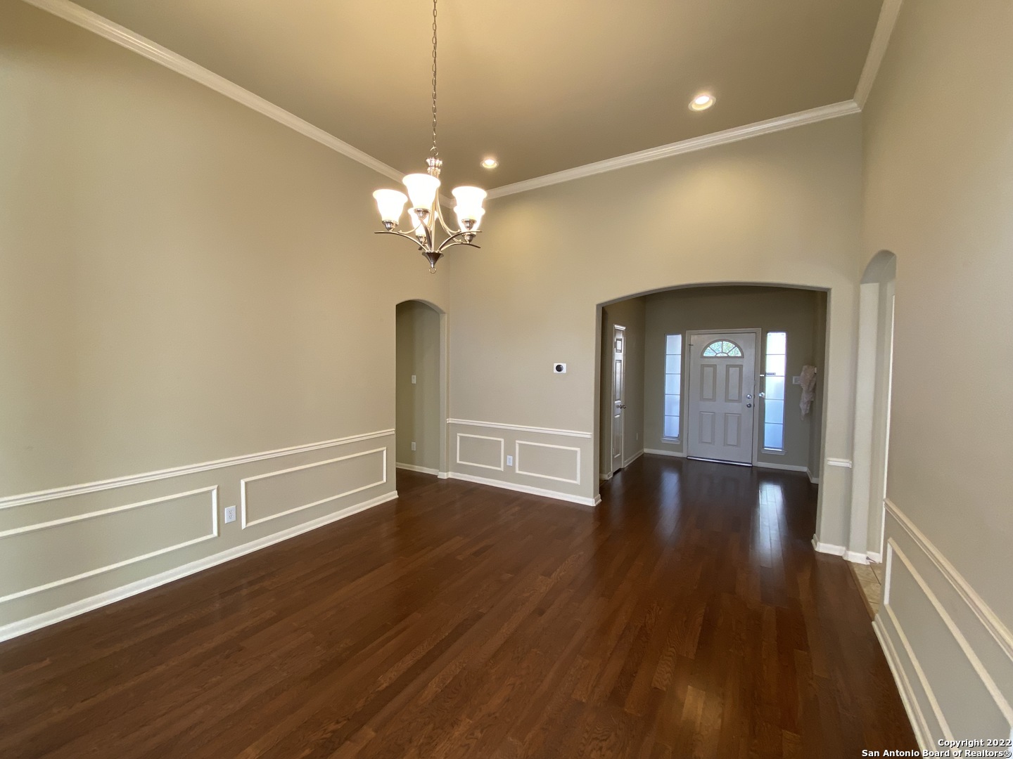 15518 Portales Pass Helotes, TX 78023 - Photo 4 of 25 a view of an empty room with wooden floor and a window