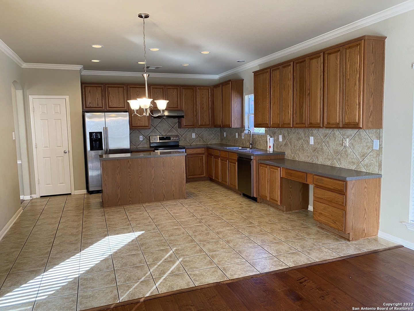 15518 Portales Pass Helotes, TX 78023 - Photo 5 of 25 a kitchen with kitchen island granite countertop a sink cabinets and stainless steel appliances