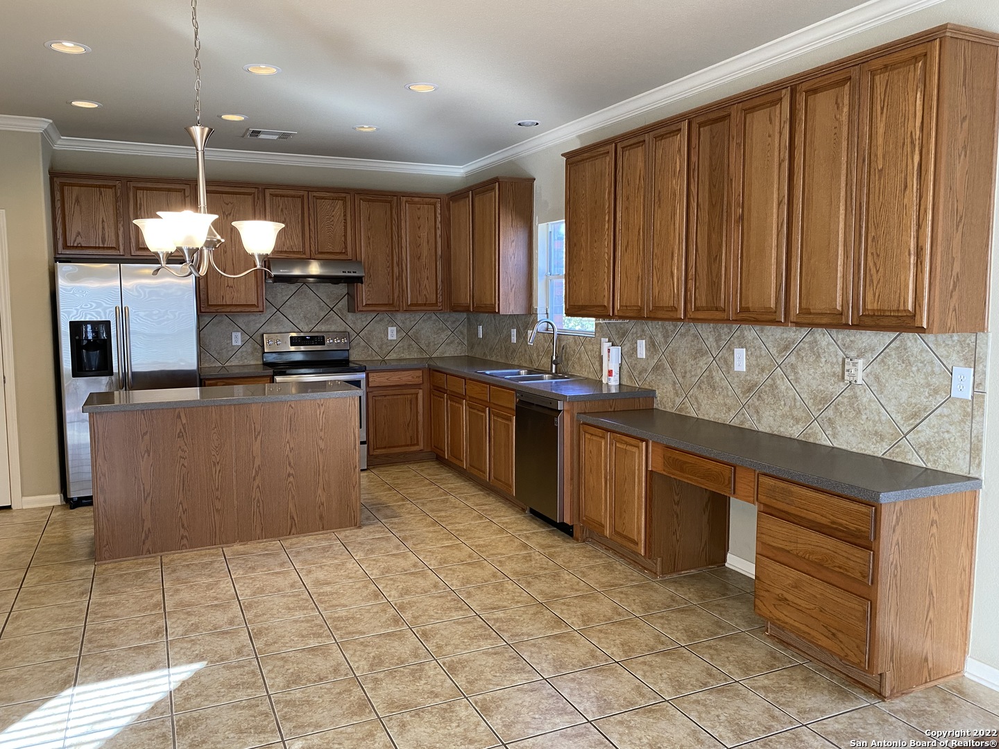 15518 Portales Pass Helotes, TX 78023 - Photo 6 of 25 a kitchen with stainless steel appliances granite countertop a stove sink and cabinets