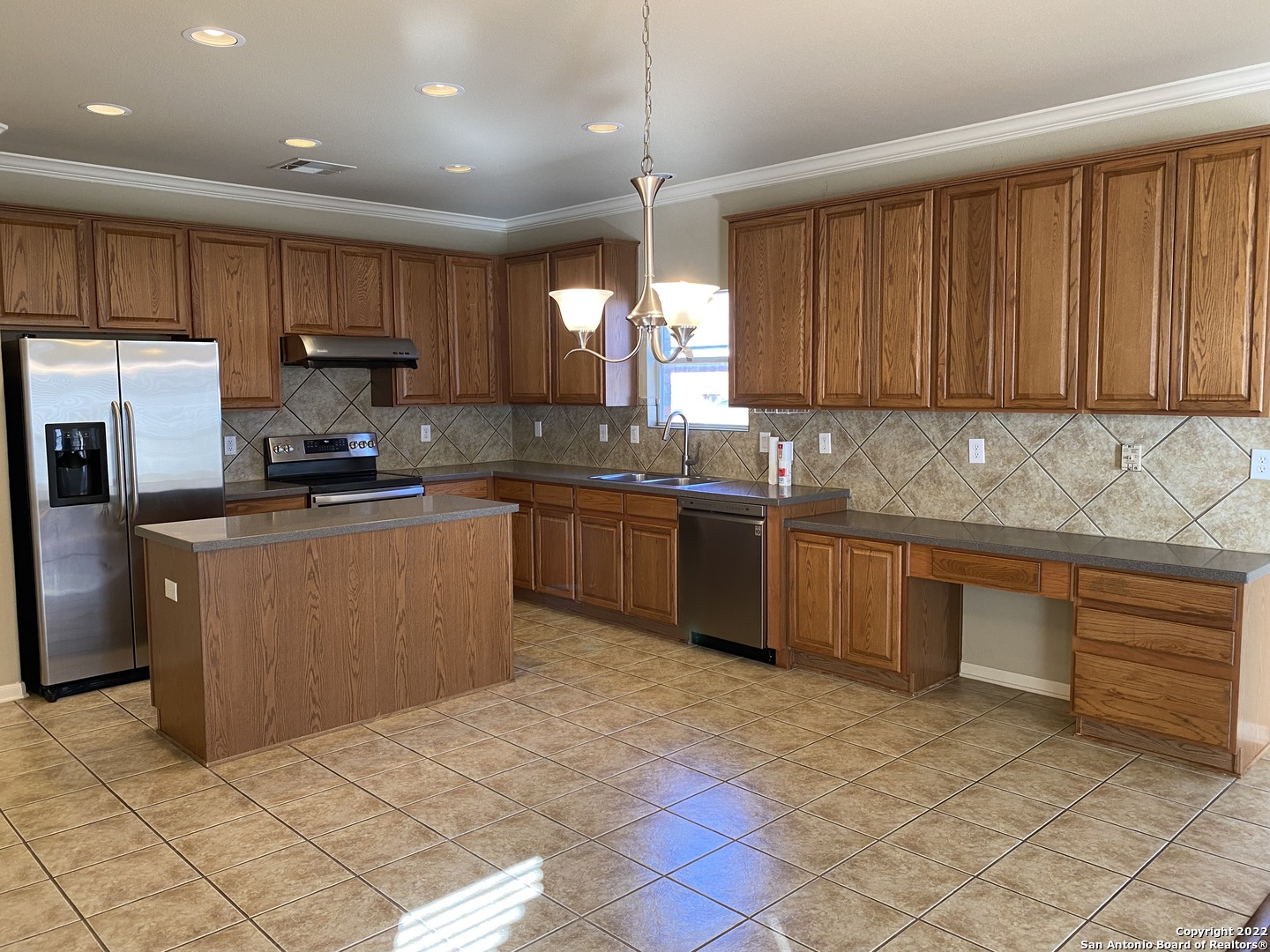 15518 Portales Pass Helotes, TX 78023 - Photo 7 of 25 a kitchen with stainless steel appliances granite countertop a stove top oven a sink dishwasher a refrigerator and a microwave