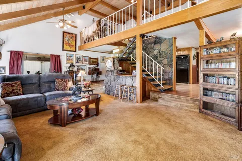 a view of a house with backyard porch and sitting area