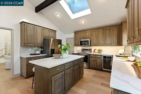 a kitchen with a sink stove and refrigerator