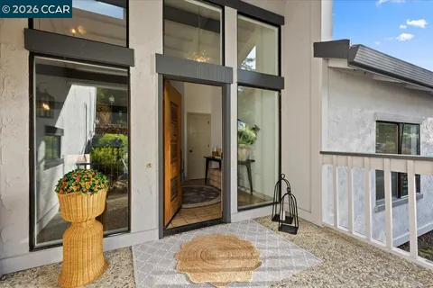 a front view of a house with outdoor seating space