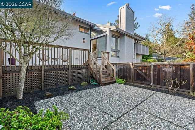 a view of a house with a wooden fence