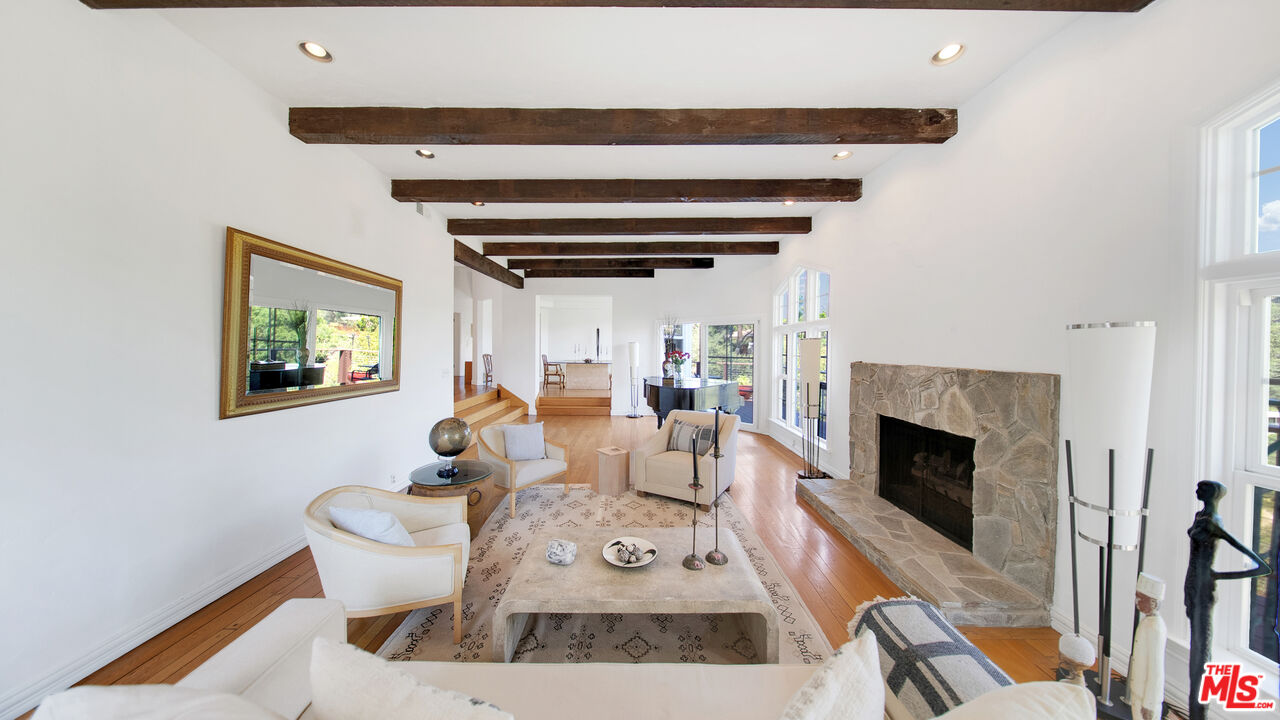 2312 Kimridge Road Beverly Hills, CA 90210 - Photo 25 of 60 a living room with furniture and a fireplace