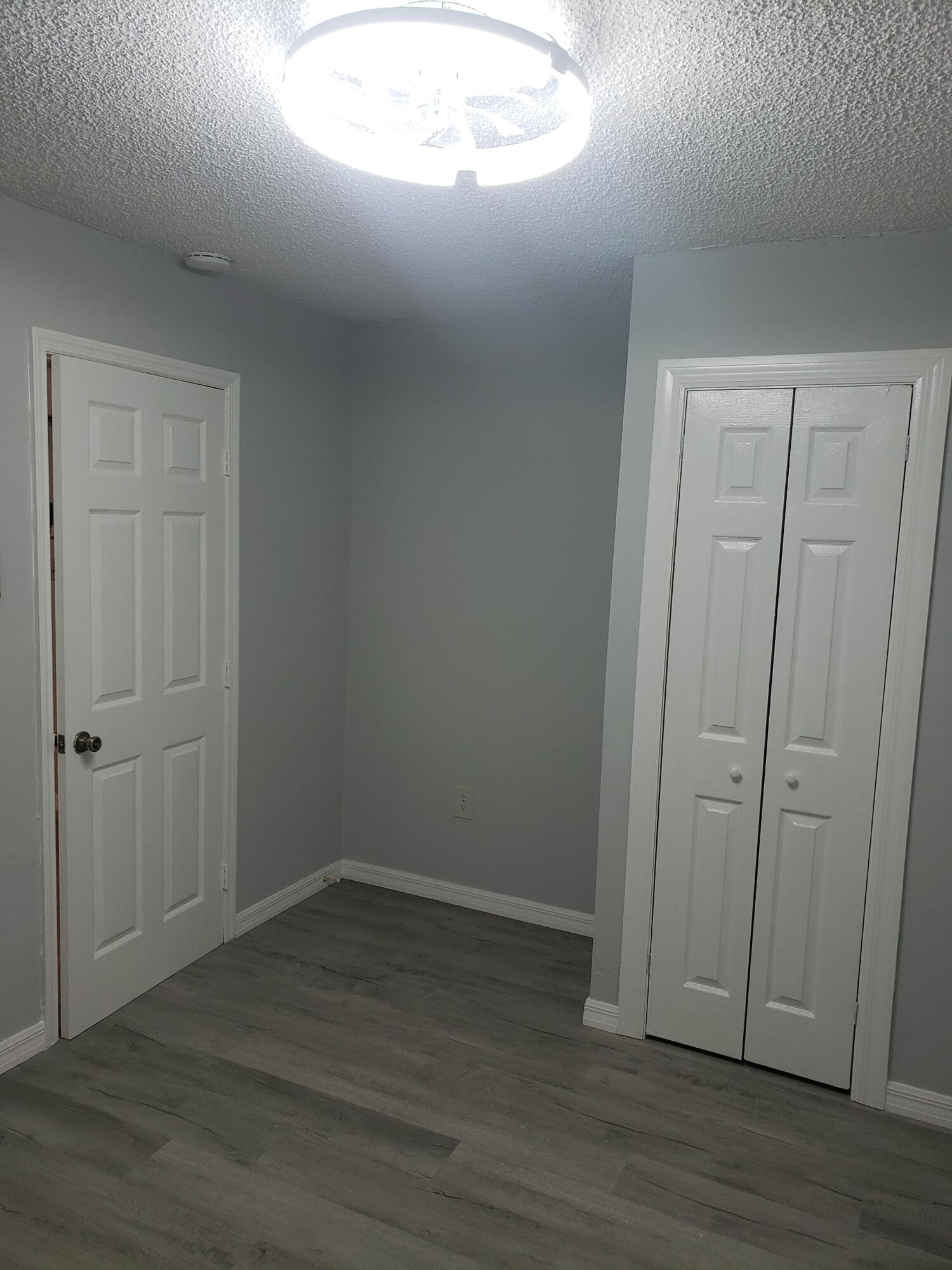 2106 Henry Street Northeast, Unit A Palm Bay, FL 32905 - Photo 4 of 8 a view of empty room with wooden floor
