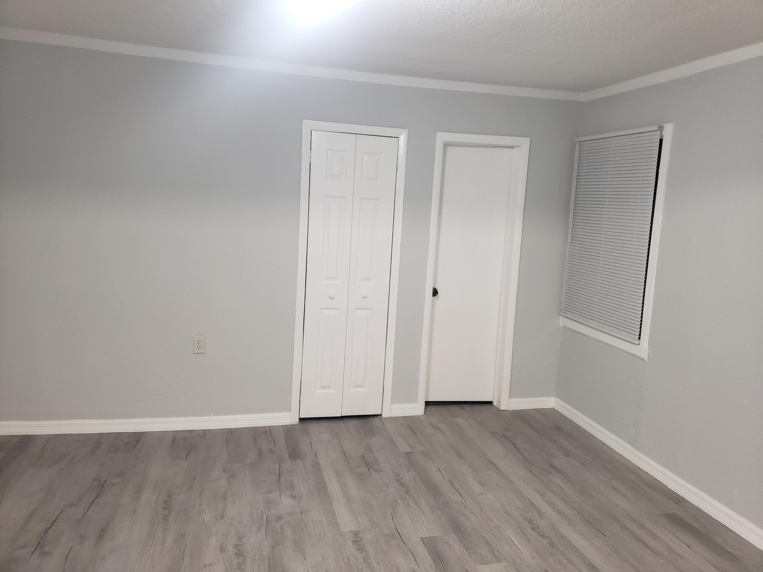 2106 Henry Street Northeast, Unit A Palm Bay, FL 32905 - Photo 7 of 8 a view of an empty room with wooden floor and closet