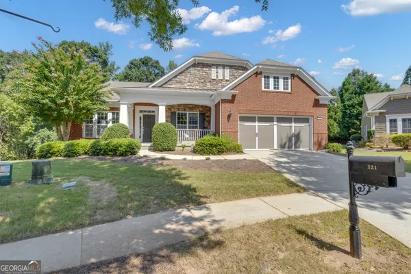 a front view of a house with a garden