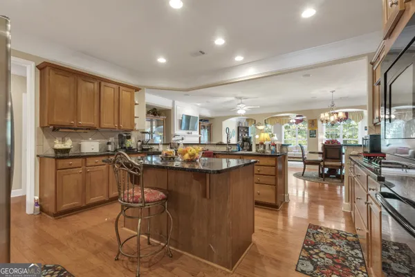 a view of a dining room with furniture and a chandelier