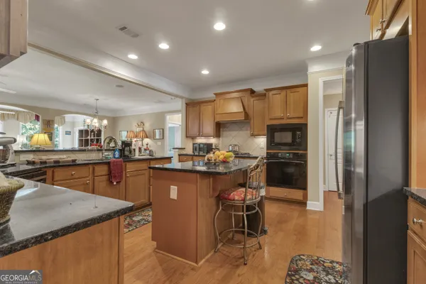 a view of a dining room with furniture and a chandelier