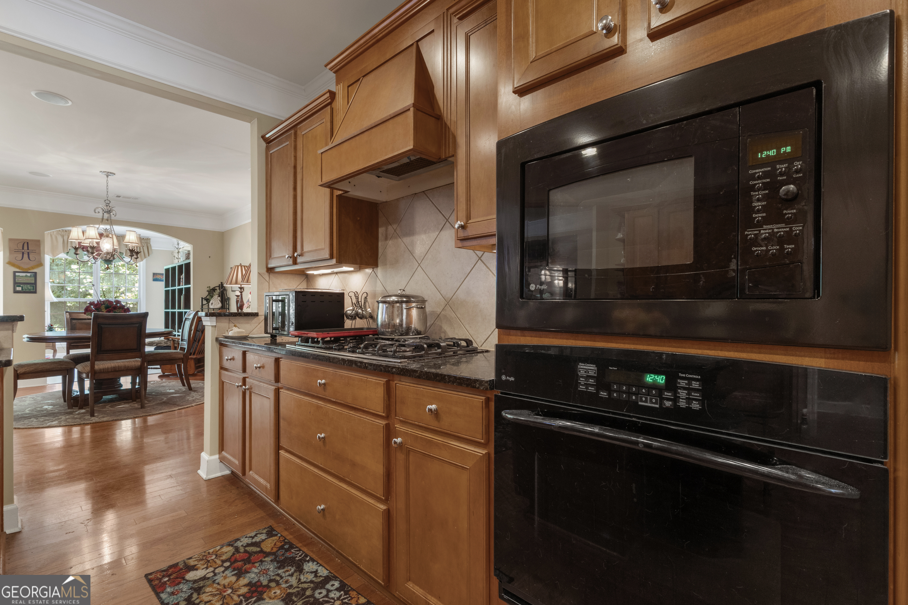 321 Anna Ruby Court Griffin, GA 30223 - Photo 15 of 81 a kitchen with stainless steel appliances a stove a sink and a microwave