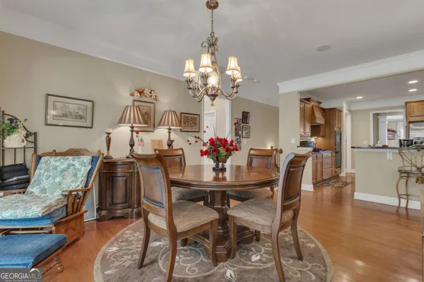 a living room with lots of furniture and view of kitchen