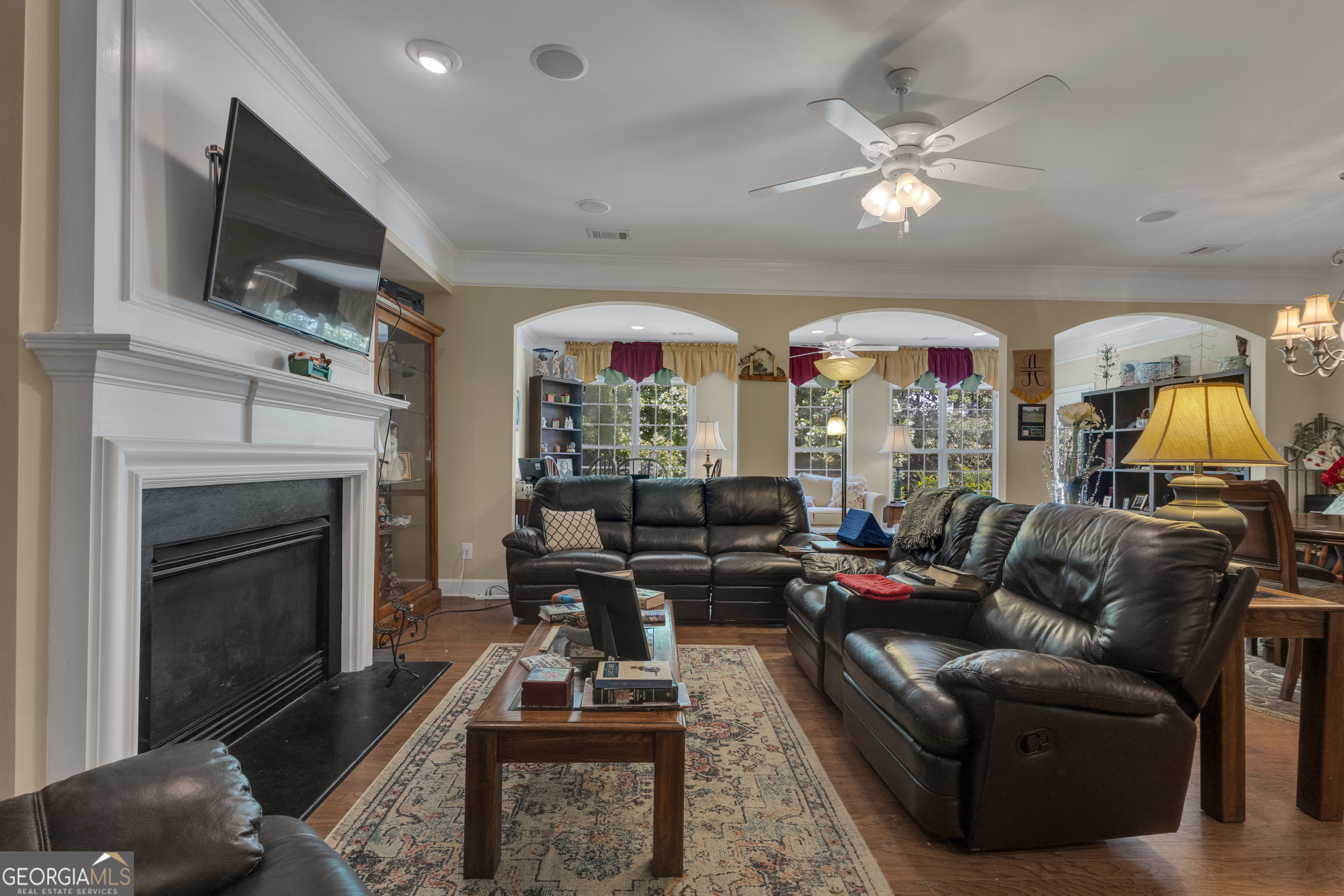 321 Anna Ruby Court Griffin, GA 30223 - Photo 24 of 81 a living room with furniture a flat screen tv and a fireplace