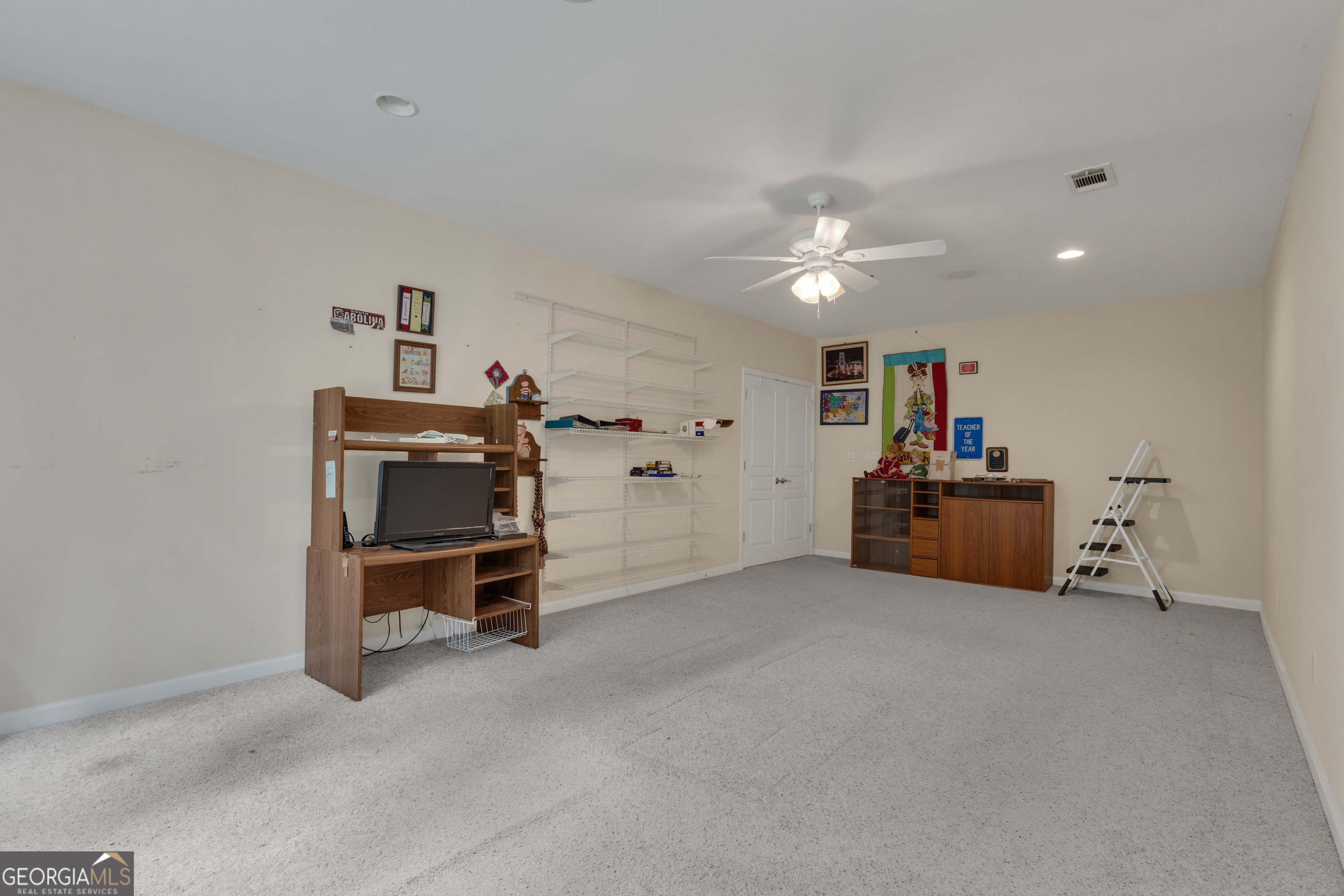 321 Anna Ruby Court Griffin, GA 30223 - Photo 51 of 81 a view of a workspace with furniture and a chandelier fan