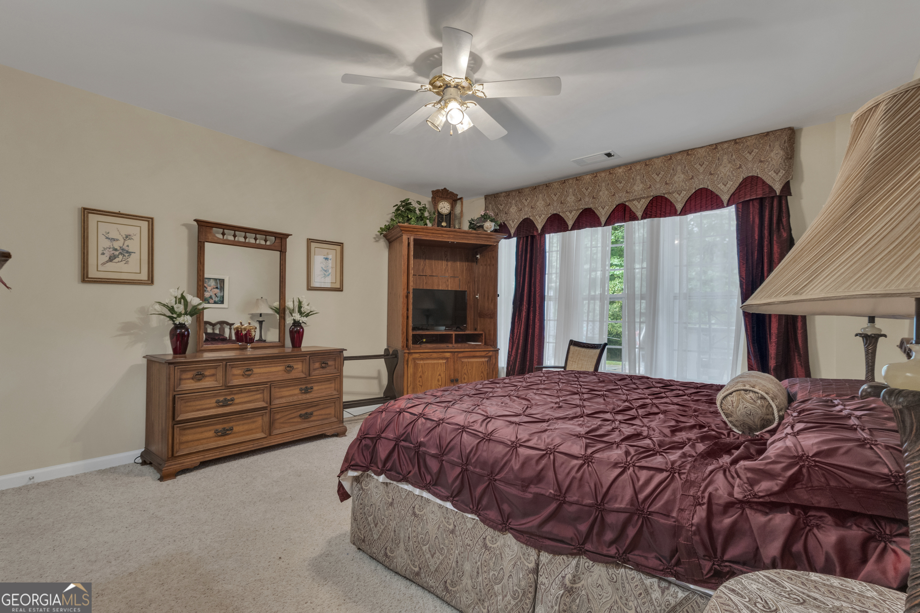 321 Anna Ruby Court Griffin, GA 30223 - Photo 58 of 81 a bedroom with a bed and a chandelier