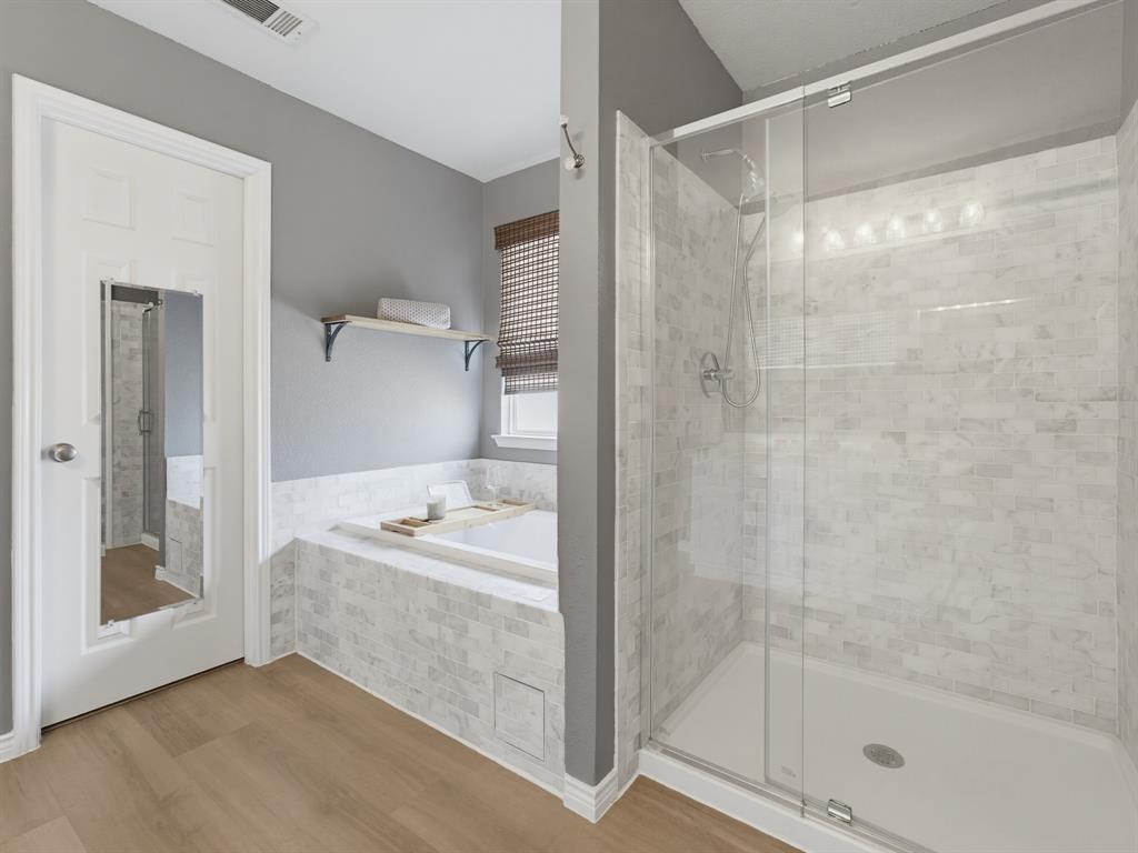 13268 Fencerow Road Fort Worth, TX 76244 - Photo 7 of 25 Contemporary bathroom featuring a spacious walk-in shower with clear glass enclosure and subway tile surround