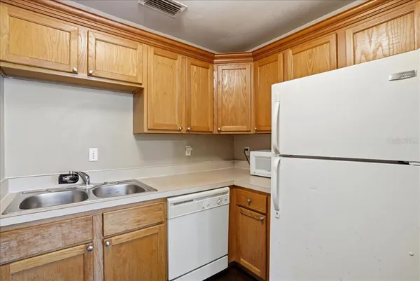a white refrigerator freezer sitting inside of a kitchen