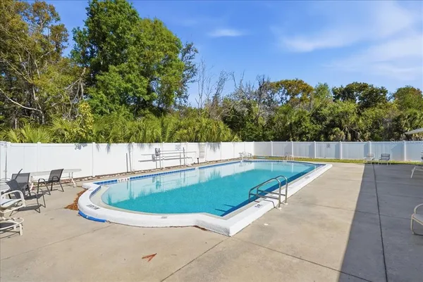 a view of a swimming pool with a yard
