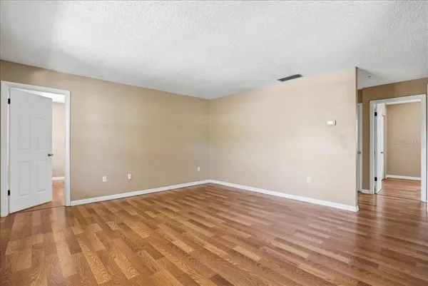 a view of an empty room and wooden floor