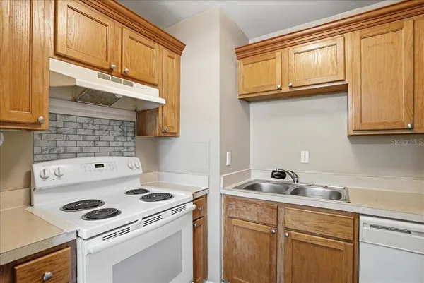 a kitchen with a stove cabinets and a sink