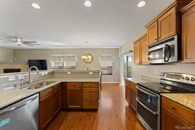 a kitchen with stainless steel appliances granite countertop a sink and stove top oven