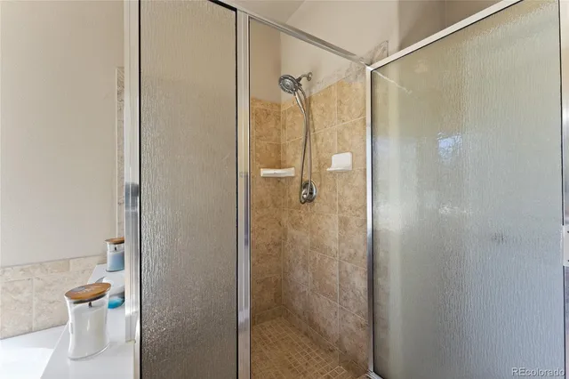 a bathroom that has a glass shower door