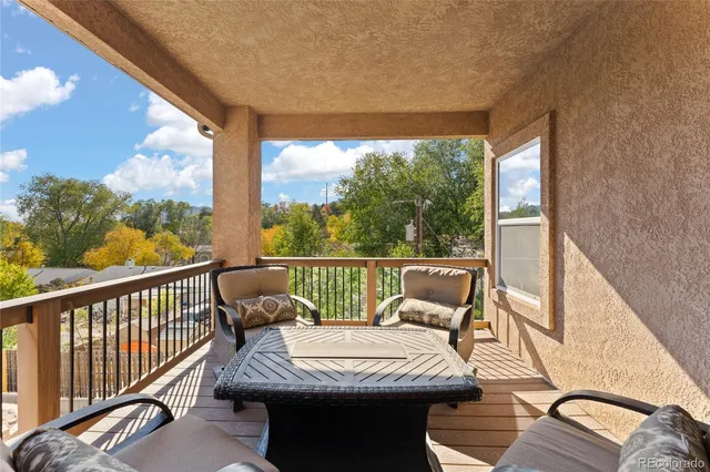 a view of a two chairs in the balcony