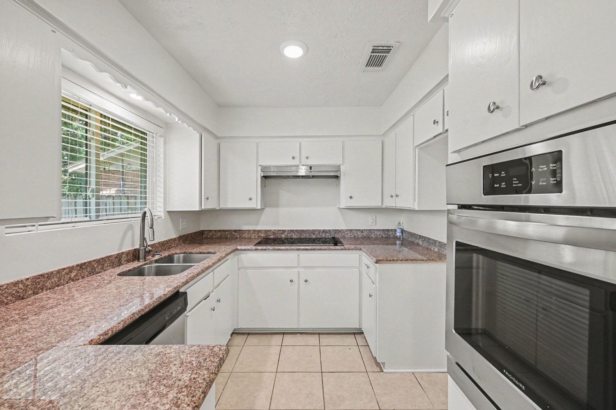 9315 Val Verde Street Houston, TX 77063 - Photo 7 of 27 Kitchen with granite counters and stainless steel appliances.