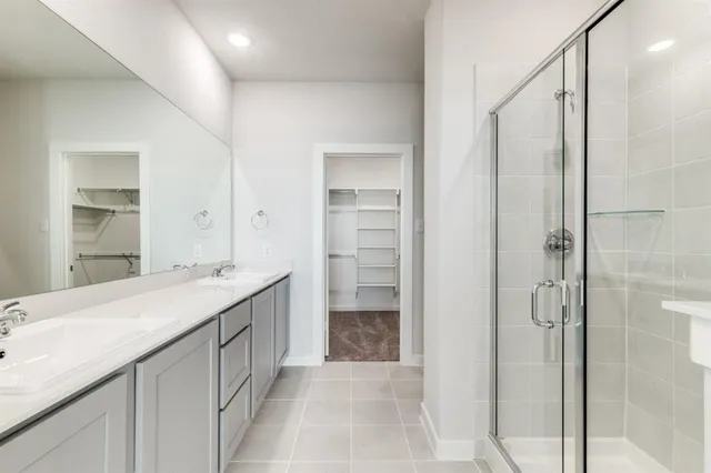 a bathroom with a double vanity sink and a mirror