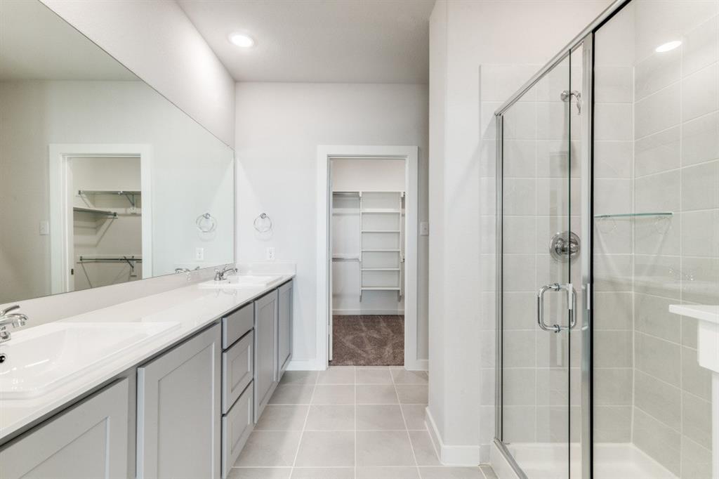 107 Huckleberry Road Forney, TX 75126 - Photo 13 of 30 a bathroom with a double vanity sink and a mirror