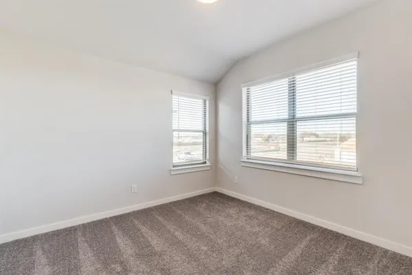 an empty room with a empty space and windows