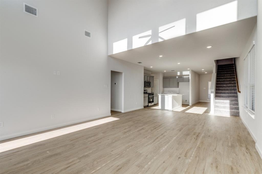 107 Huckleberry Road Forney, TX 75126 - Photo 5 of 30 an empty room with wooden floor and windows