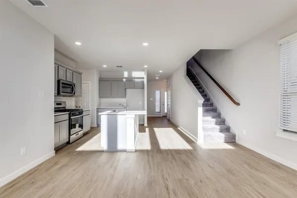a view of kitchen with furniture and wooden floor