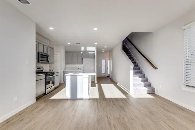a view of kitchen with furniture and wooden floor