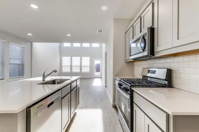 a kitchen that has a sink and a stove