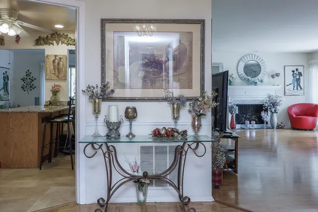 a kitchen with stainless steel appliances granite countertop a table and chairs in it