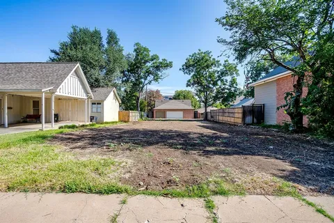 a backyard of a house with plants and trees
