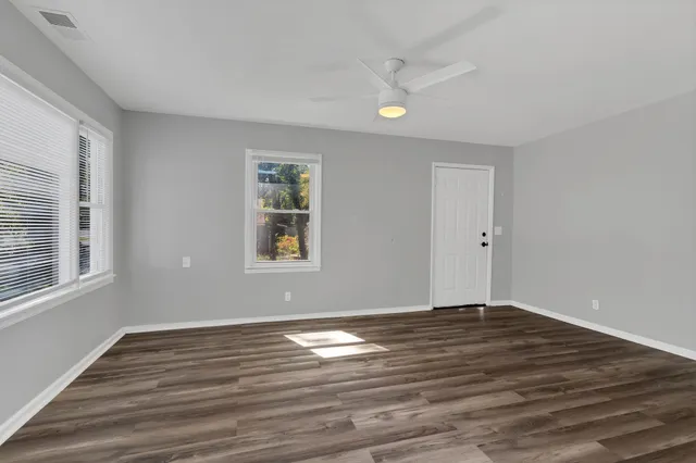 a view of wooden floor and windows in a room