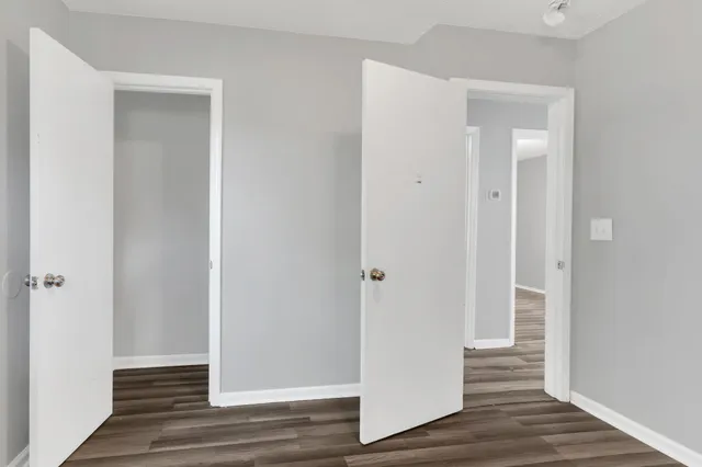 a view of a hallway with wooden floor
