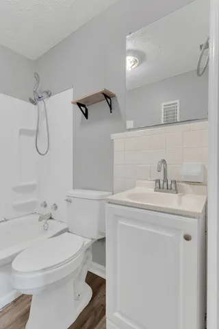 a bathroom with a sink a toilet and a mirror