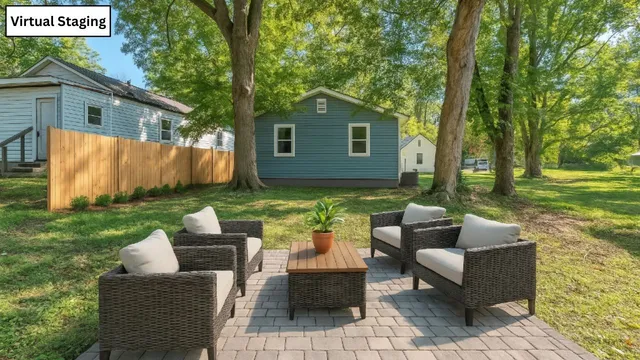 a backyard of a house with table and chairs