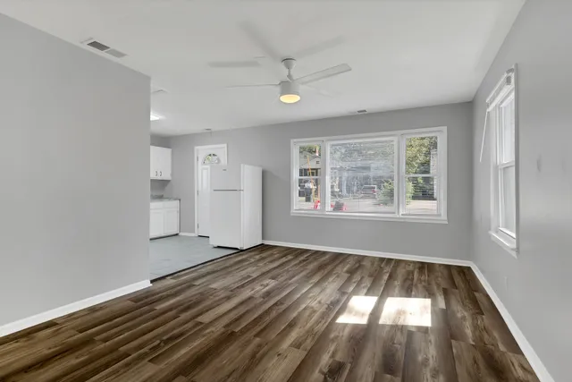 wooden floor in an empty room with a window