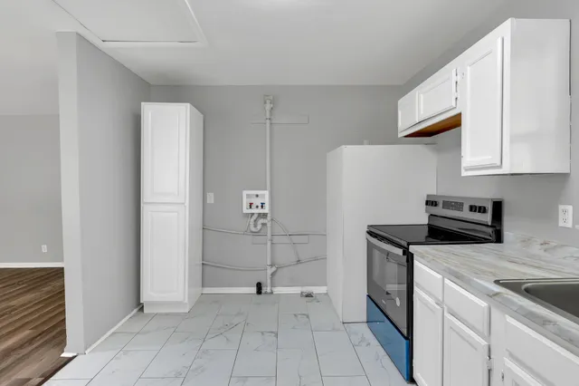 a kitchen with a stove a sink and a refrigerator