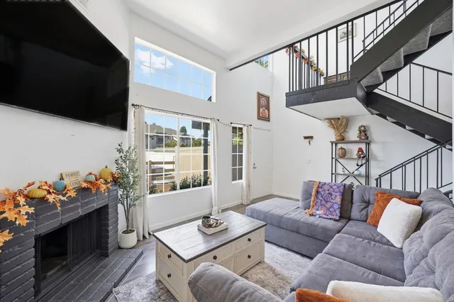 a living room with furniture fireplace and flat screen tv