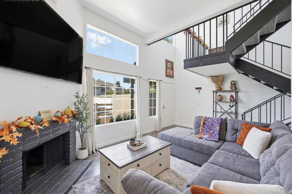 8765 Spring Canyon Drive Spring Valley, CA 91977 - Photo 1 of 37 a living room with furniture fireplace and flat screen tv