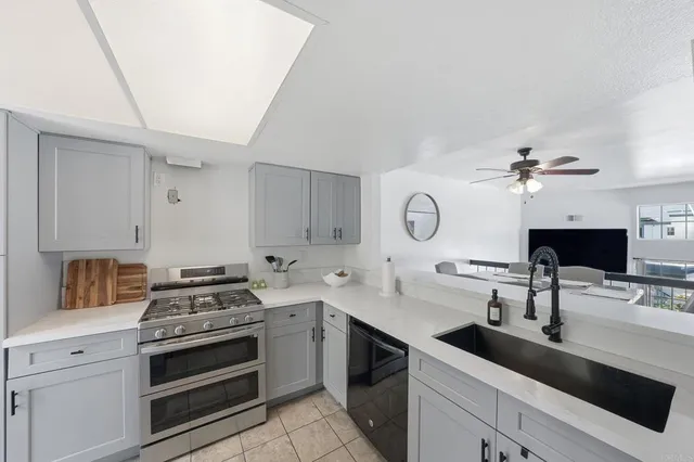 a kitchen with a stove and a white refrigerator