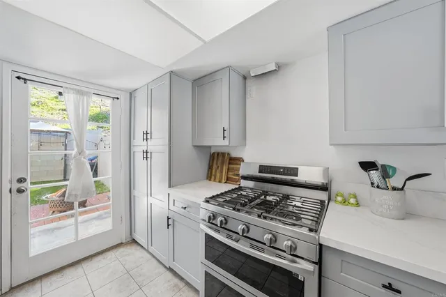 a kitchen with a sink stove and cabinets