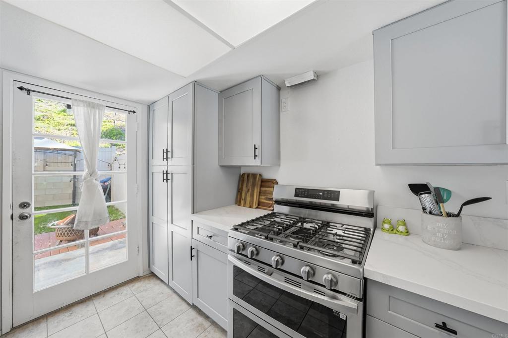 8765 Spring Canyon Drive Spring Valley, CA 91977 - Photo 12 of 37 a kitchen with a stove and a white refrigerator