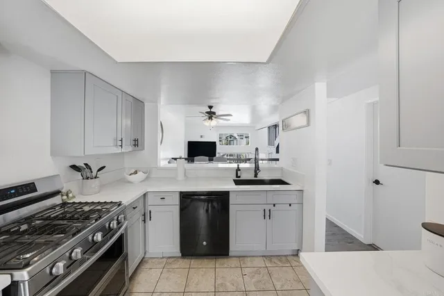 a kitchen with a sink appliances and cabinets