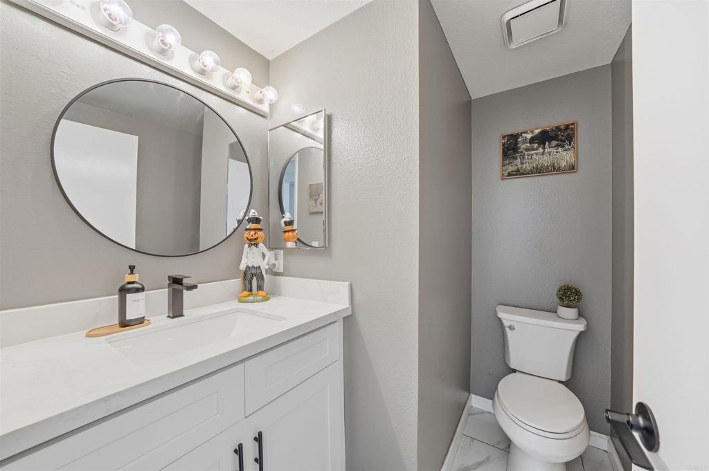 8765 Spring Canyon Drive Spring Valley, CA 91977 - Photo 16 of 37 a bathroom with a toilet sink and mirror
